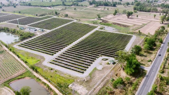 Photovoltaic solar cells farm industrial for renewable energy power. Solar electrical produce is infrastructure and modern technology. Aerial view flying over vitality sustainable environment force.