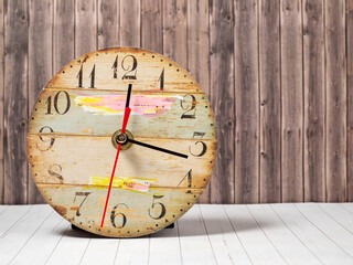 Retro clock on a wooden background. Clock close-up.