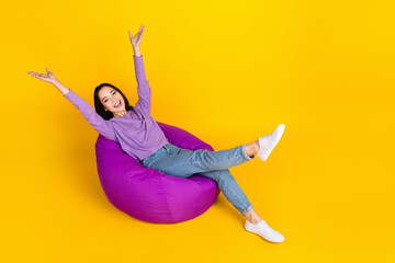 Full length photo of careless girl chilling hands up relax time dormitory beanbag vacation weekend...