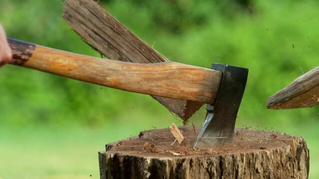 Super slow motion of chopping wooden logs with axe. Filmed on high speed cinema camera, 1000 fps.