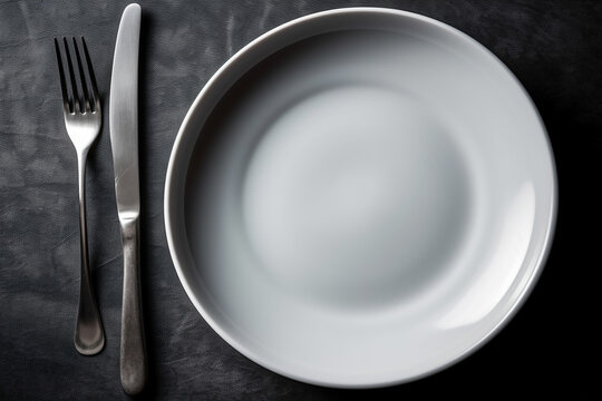 Food disorder concept. Empty plate, fork and knife. Top view.