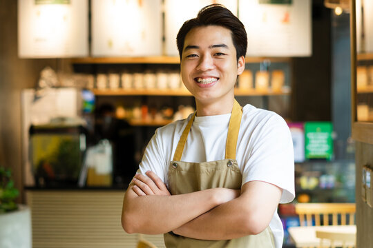 Asian Man Sitting At Coffee Shop