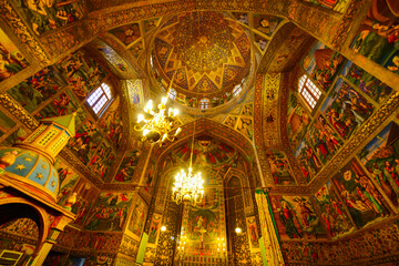 Fototapeta na wymiar Fabulous interior view of prayer hall at the Holy Savior Cathedral (Vank Cathedral) in the New Julfa district. Carpets and frescos of the Armenian Apostolic Church.