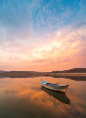 beautiful landscape with a boat and the sun