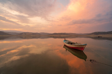 beautiful landscape with a boat and the sun