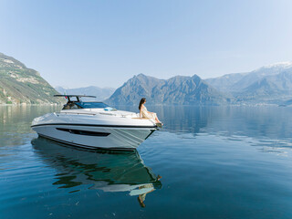 young amazing woman relax on the yacht, aerial view