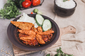 Otak otak sambal gami or spicy fish cake is Traditional food from Indonesia. served on plate with a bowl of rice and vegetables. Isolated gray background and