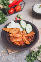 Otak otak sambal gami or spicy fish cake is Traditional food from Indonesia. served on plate with a bowl of rice and vegetables. Isolated gray background and