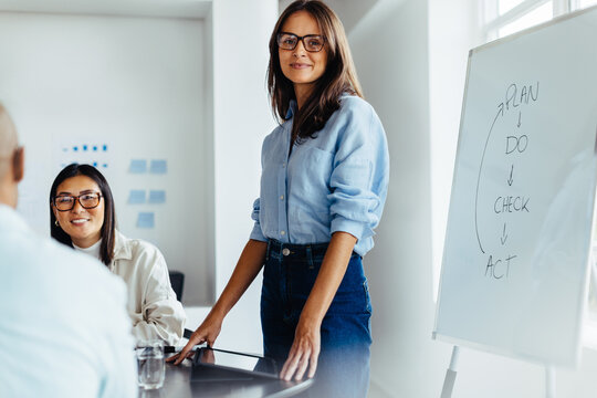 Female Team Leader Giving A Presentation In An Office