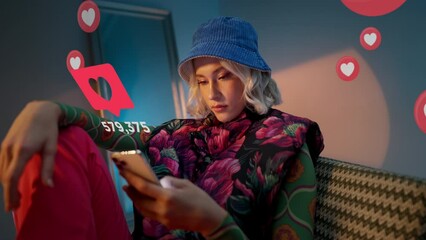 Blonde young trendy woman using her phone to interact with social media, getting followers, likes, emoji feedback - Powered by Adobe