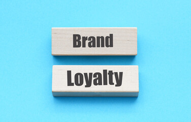 Brand Loyalty words on wooden blocks and blue background.