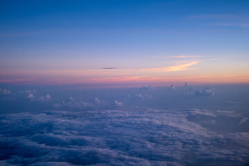 Beautiful view of cumulus clouds with sunrise at atmosphere from airplane window, sunset sunrise from airplane window