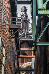 Part of the abandoned coal and steel production plant in Landschaftspark Duisburg-Nord. The landscape park is a public park around a disused iron and steel works in Duisburg, Germany. Vertical.