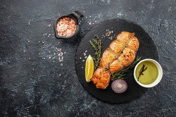 delicious salmon steak with spices and herbs on a dark background, banner, menu, recipe place for text, top view