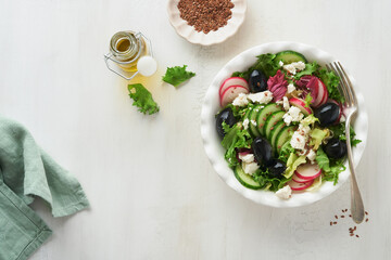 Lettuce salad, cucumber, radish salad with cottage cheese and flax seeds olive oil salad. Healthy diet food. Diet menu and balanced diet. Top view.