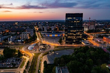 Aerial drone photo of Katowice centre with roundabout and modern office towers at evening....