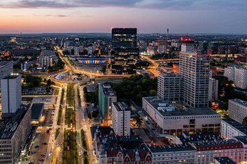 Aerial drone photo of Katowice centre with roundabout and modern office towers at evening....