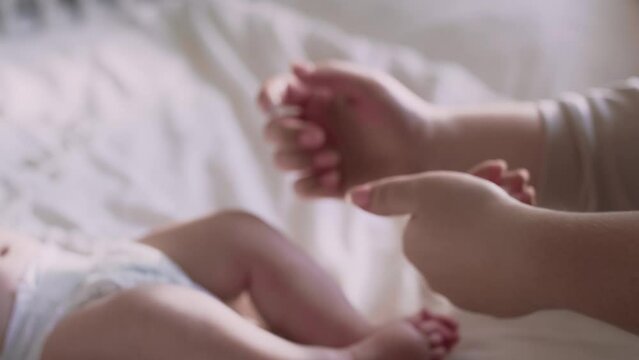 Mother applying moisturizing balm on baby's feet. Shot with RED helium camera in 8K.    