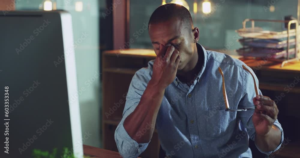Poster Young, professional and tired with glasses is working at the office on a pc with stress and anxiety. Businessman, burnout and frame on a computer has fatigue at his desk at the office is overworked.