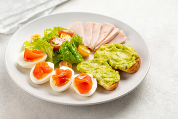 Healthy breakfast with eggs salmon and avocado toasts