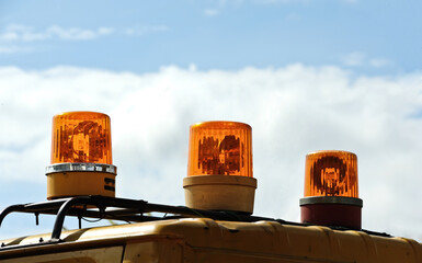yellow emergency light on the car. Light signal on special equipment orange light siren.