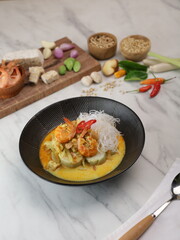 Rice cakes and vegetables curry served with boiled egg, prawn and rice cracker. Indonesian traditional cuisine from Sumatra.