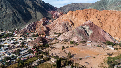 The hill of 7 colors and a soccer field in the picturesque town of Purmamarca in the province of Jujuy from the air