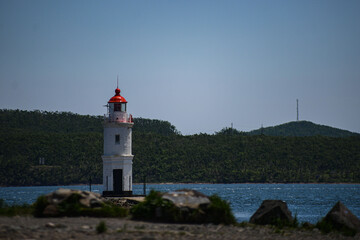 lighthouse in a sunny day in the sea. High quality photo