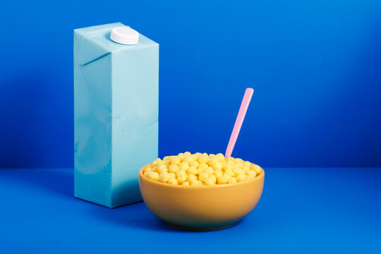 Generative AI illustration of bowl with cereals and spoon placed near bottle of water on blue background representing concept of recycling packaging
