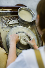 close up view of professional potter working on pottery wheel at workshop. High quality photo