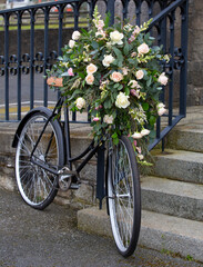 wedding bicycle with flowers outside a church