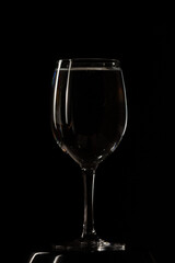 Glass with water on black background