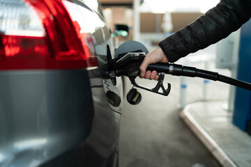 Fuel nozzle filling up car with fuel