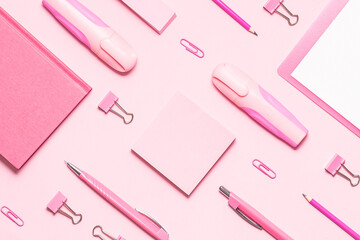 Pink stationery set on light pink background. Seamless pattern, top view. Back to school background. Creative office desktop.