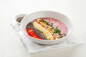 Portion of healthy smoothie bowl with banana and strawberries