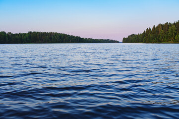 summer lake trip on boat, exploring and traveling in Europe. Beautiful sunset, water and trees. Active lifestyle concept