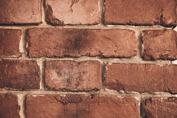 Abstract weathered texture stained with aged paint, rough rusty masonry blocks. Close-up of a brick wall. Overlay for your design with the ability to copy. High quality photo