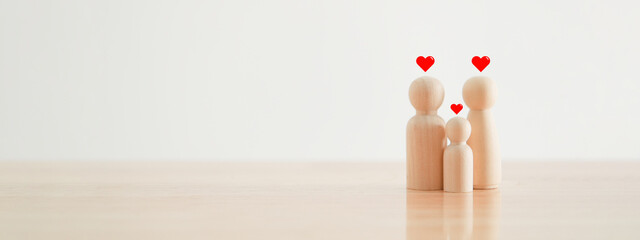 Happy family with one child and heart emotion on wooden background. Wood doll character. Togetherness relationship and lifestyle concept.