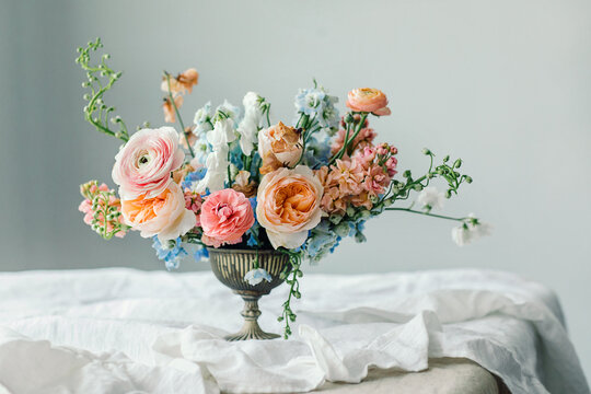 Still Life Of Flowers Bouquet In Vintage Vase On White Linen French Tablecloth