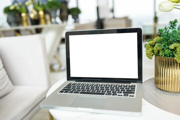 Laptop with Mock up blank screen on table in front of cafe space for text. product display computer laptop montage- technology concept