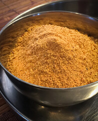 Indian chutney powder in a small steel bowl