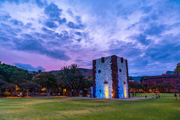 Fototapeta premium Beautiful park with the Torre del Conde illuminated at night in San Sebastian de La Gomera, Canary Islands.