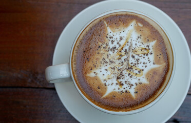 A coffee on the wood table background. Top view
