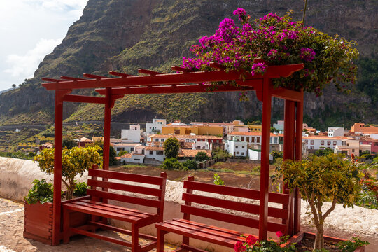Red benches on the streets in the village of Agulo in the north of La Gomera in summer, Canary Islands