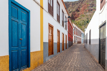 Colored doors and windows to the streets in the village of Agulo in the north of La Gomera in summer, Canary Islands