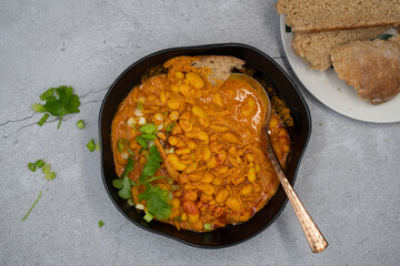 Vegan bean curry bowl, served with bread slices
