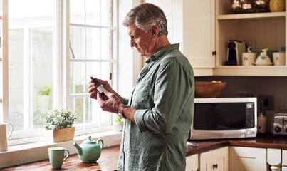 CBD oil, tea and a senior man in the kitchen of a retirement home for his morning medication routine. Thinking, medical cannabis and dose with a mature man holding a medicine bottle in his house - obrazy, fototapety, plakaty