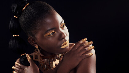 Beauty, glitter and black woman in studio for makeup, art and confidence on black background. Face, creative and African female model pose with jewelry for wealth, royal and luxury gold aesthetic