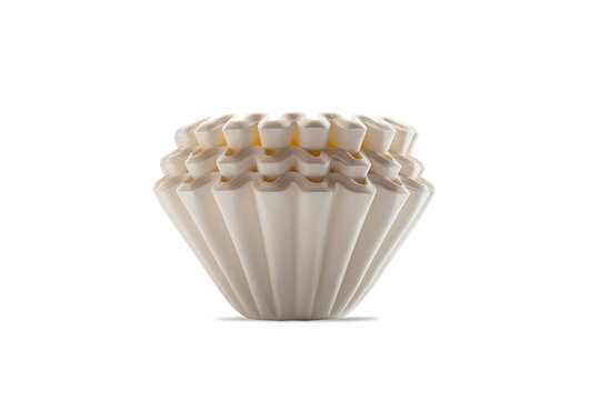 Side view closeup stack of new unbleached basket-type disposable paper coffee filters isolated on white background with clipping path.