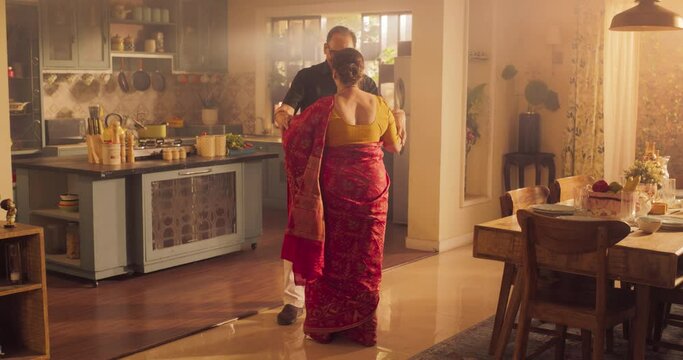 Elderly Couple Dancing  Kitchen and Enjoying Each Other's Company: Moving to the Rhythm of Music  and Love, With Smiling Faces and Loving Embrace, Celebrate Anniversary. Slow Motion Wide